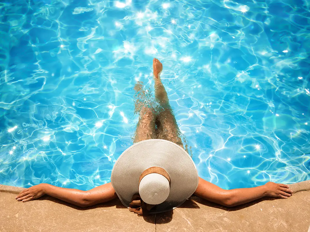 Woman swimming in a fiberglass swimming pool in the morning